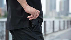 Man in black clothing with empty wallet pocket in urban setting